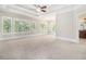 A carpeted main bedroom features trey ceilings, crown molding, and plenty of natural light at 135 Waterlace Way, Fayetteville, GA 30215