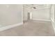 Large primary bedroom with carpet flooring, ceiling fan, and large windows at 135 Waterlace Way, Fayetteville, GA 30215