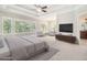 Spacious main bedroom with a sitting area, trey ceilings, large windows, and ensuite bathroom at 135 Waterlace Way, Fayetteville, GA 30215
