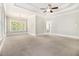 Spacious carpeted main bedroom with tray ceilings and natural light at 135 Waterlace Way, Fayetteville, GA 30215