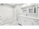 Bright bathroom featuring a tub, shower, and vanity with marble countertops at 3040 Peachtree Nw Rd # 613, Atlanta, GA 30305