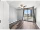 Bedroom with hardwood floors, ceiling fan, and balcony access at 3040 Peachtree Nw Rd # 613, Atlanta, GA 30305