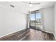 A bedroom with hardwood floors and a balcony, offering city views and natural light at 3040 Peachtree Nw Rd # 613, Atlanta, GA 30305