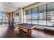 Community game room with billiards and ping pong tables, hardwood floors, and large windows at 3040 Peachtree Nw Rd # 613, Atlanta, GA 30305