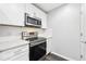 A kitchen featuring white cabinets, stainless steel appliances, and a modern design at 3040 Peachtree Nw Rd # 613, Atlanta, GA 30305
