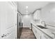 A kitchen with stainless appliances, white cabinets, and marble countertops that offers a modern design at 3040 Peachtree Nw Rd # 613, Atlanta, GA 30305
