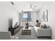 A living room featuring a sofa and chairs with a balcony that offers city views and natural light at 3040 Peachtree Nw Rd # 613, Atlanta, GA 30305
