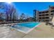 A refreshing swimming pool with lounge chairs and ample seating on a sunny day at 3040 Peachtree Nw Rd # 613, Atlanta, GA 30305