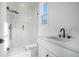 Modern bathroom with frameless glass shower and white marble at 4332 Kay Morgan Rd, Buford, GA 30519