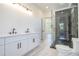 A bathroom featuring double vanities and a glass shower with dark accents at 4332 Kay Morgan Rd, Buford, GA 30519
