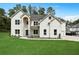 Charming two-story home featuring a manicured lawn, brick facade, and a welcoming arched entryway at 4332 Kay Morgan Rd, Buford, GA 30519