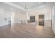 Open living room with wet bar, chandelier, and view to entry at 4332 Kay Morgan Rd, Buford, GA 30519