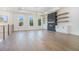 Open living room with fireplace, built-ins, and three large windows at 4332 Kay Morgan Rd, Buford, GA 30519
