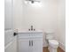 Elegant powder room with marble countertop, and modern fixtures at 4332 Kay Morgan Rd, Buford, GA 30519