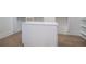 Walk-in closet features white cabinets with an island and hardwood floors at 4332 Kay Morgan Rd, Buford, GA 30519