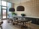 A communal dining area features a long table, pendant lighting, and stylish decor at 1080 Peachtree Ne St # 2915, Atlanta, GA 30309