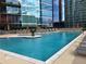 Sparkling swimming pool surrounded by lounge chairs, tables, and lush landscaping at 1080 Peachtree Ne St # 2915, Atlanta, GA 30309