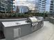 Outdoor kitchen featuring a gas grill, counter space, and sink at 1080 Peachtree Ne St # 2915, Atlanta, GA 30309