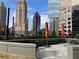 Relaxing rooftop terrace with outdoor seating, shade umbrellas, and city views at 1080 Peachtree Ne St # 2915, Atlanta, GA 30309