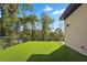 Expansive outdoor patio with artificial turf and a modern railing, perfect for entertaining and relaxing at 1604 Niskey Lake Sw Rd, Atlanta, GA 30331