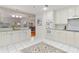 Bright white kitchen with granite countertops, modern appliances, and an open design at 211 Colonial Homes Nw Dr # 1303, Atlanta, GA 30309