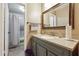 Bathroom with gray vanity, granite countertop, mirror, and shower with gray tile at 3251 Abbeywood Dr, Decatur, GA 30034