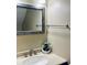 Bathroom vanity with a framed mirror, a towel bar, decorative plant, and neutral toned walls at 3251 Abbeywood Dr, Decatur, GA 30034