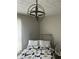 Cozy bedroom illuminated by a modern light fixture, featuring a bed and a decorative chair at 3251 Abbeywood Dr, Decatur, GA 30034