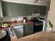Kitchen area with stainless steel appliances, olive cabinets, and laminate countertops, providing a functional cooking space at 3251 Abbeywood Dr, Decatur, GA 30034