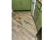 Hardwood style kitchen floors and painted green cabinetry create a warm and inviting space at 3251 Abbeywood Dr, Decatur, GA 30034