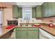 Traditional kitchen featuring olive colored cabinets and laminate countertops with a window above the sink at 3251 Abbeywood Dr, Decatur, GA 30034