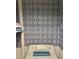 Unique blue patterned tiled walls create a charming laundry room space with a washing machine at 3251 Abbeywood Dr, Decatur, GA 30034