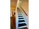 Modern stairwell with freshly painted black stairs, white risers, and matching handrail adds clean lines at 3251 Abbeywood Dr, Decatur, GA 30034
