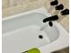 This is a white tub with black fixtures at 3251 Abbeywood Dr, Decatur, GA 30034