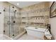 This primary bath has a glass shower, soaking tub with decoratively tiled walls and built-in shelves for soaps and décor at 3636 Brookleigh Ln, Brookhaven, GA 30319