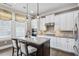 This kitchen features an island with barstool seating, granite counters, and stainless steel appliances at 3636 Brookleigh Ln, Brookhaven, GA 30319