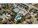 An aerial shot captures a community with tennis courts, a pool, winding roads and mature trees surrounding upscale homes at 3890 Pleasant Woods Dr, Cumming, GA 30028