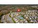 An aerial view pinpoints the location of a neighborhood with community amenities nestled amongst a mix of homes and lush foliage at 3890 Pleasant Woods Dr, Cumming, GA 30028