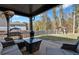 Inviting back patio features grill, seating, and a view of the backyard and spa at 3890 Pleasant Woods Dr, Cumming, GA 30028