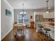 Charming dining area with wood floors, a stylish light fixture, and ample seating at 3890 Pleasant Woods Dr, Cumming, GA 30028