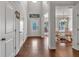 Inviting entryway with wood floors, a decorative transom window, and an open view of the dining area at 3890 Pleasant Woods Dr, Cumming, GA 30028