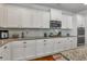 This kitchen offers white cabinets, granite countertops, and modern stainless steel appliances at 3890 Pleasant Woods Dr, Cumming, GA 30028