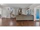 Open-concept living room featuring a fireplace, hardwood floors, and staircase to the second floor at 3890 Pleasant Woods Dr, Cumming, GA 30028