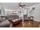 Bright living room featuring an open layout to the kitchen and hardwood floors at 3890 Pleasant Woods Dr, Cumming, GA 30028