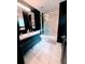 Contemporary bathroom featuring double vanity with black cabinets and glass enclosed shower at 657 S Grand Nw Ave, Atlanta, GA 30318