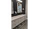 Elegant bathroom boasts double vanity with marble countertop and sleek fixtures at 657 S Grand Nw Ave, Atlanta, GA 30318