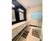 Modern bathroom with double vanity, marble countertops, and sleek shower at 657 S Grand Nw Ave, Atlanta, GA 30318