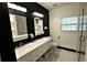 Chic bathroom features dual sinks, modern lighting, and a glass-enclosed shower at 657 S Grand Nw Ave, Atlanta, GA 30318