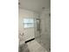 Bright bathroom with glass shower, modern fixtures, and tile flooring at 657 S Grand Nw Ave, Atlanta, GA 30318