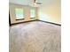 A spacious bedroom with two windows and plush carpeting at 657 S Grand Nw Ave, Atlanta, GA 30318